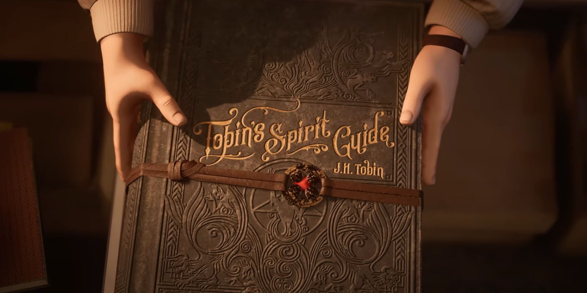 A man holding a book titled "Tobin's Spirit Guide."