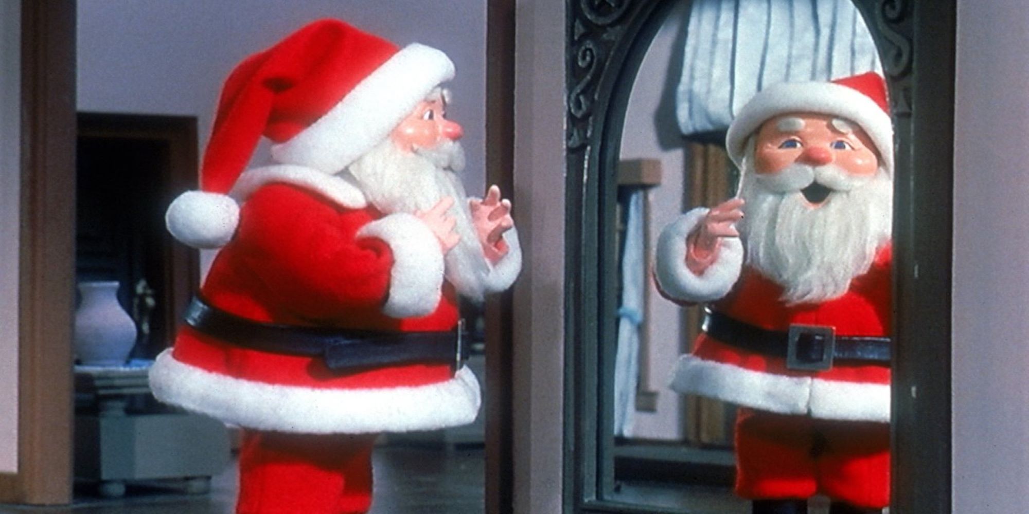 Santa Claus looks at himself in a mirror while wearing his iconic red suit in the TV special, The Year Without A Santa Claus.