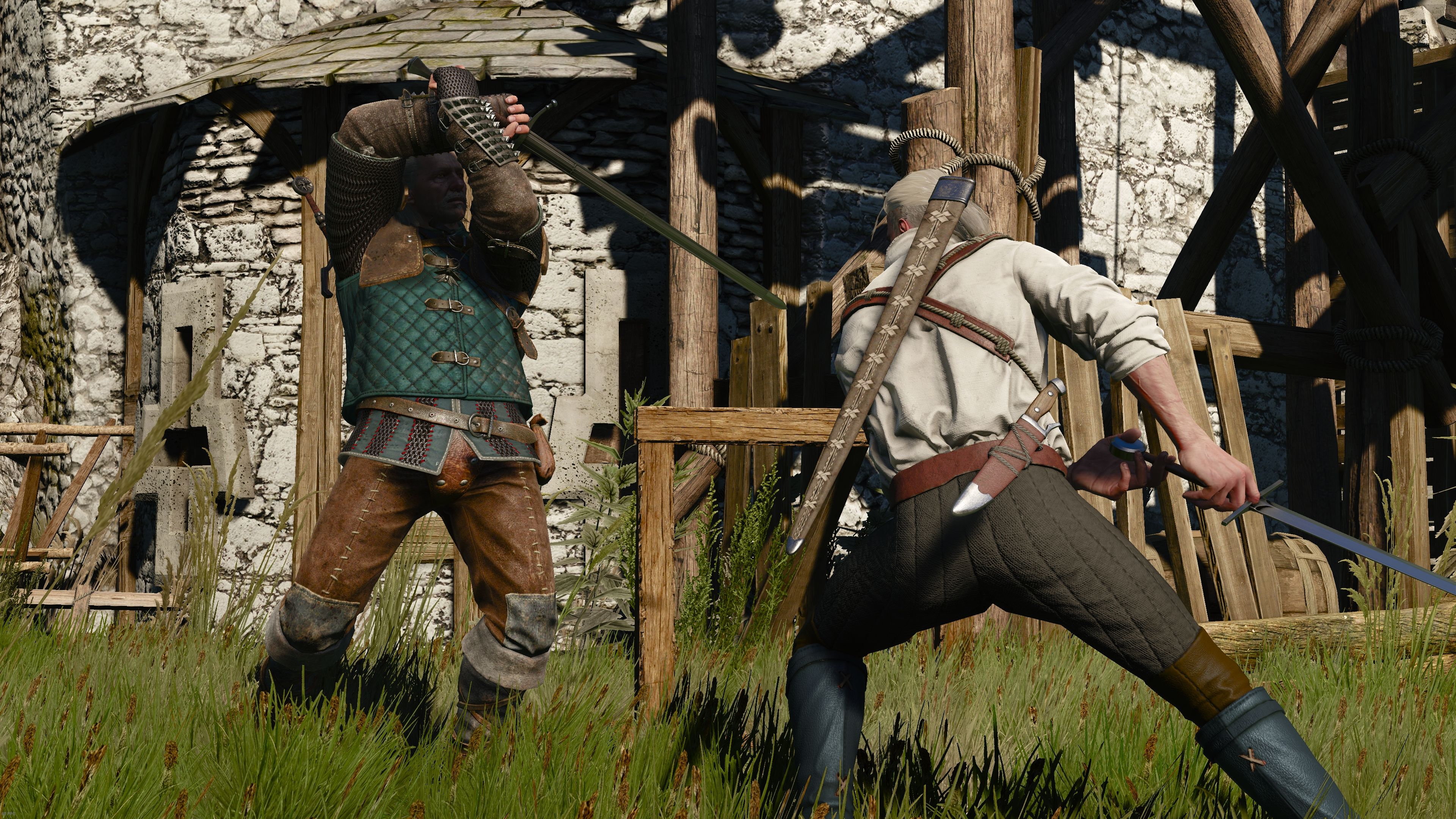 Two men spar with swords in a grassy square in the middle of a castle.