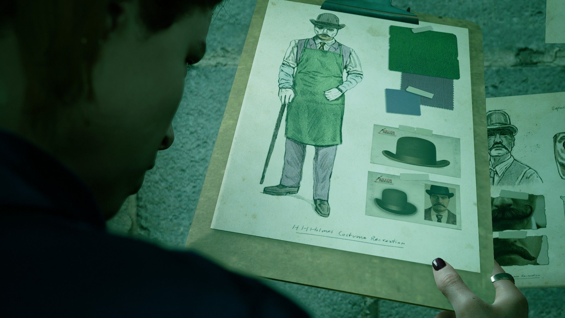 Kate examines Du'met's sketch of his Holmes costume in The Devil In Me