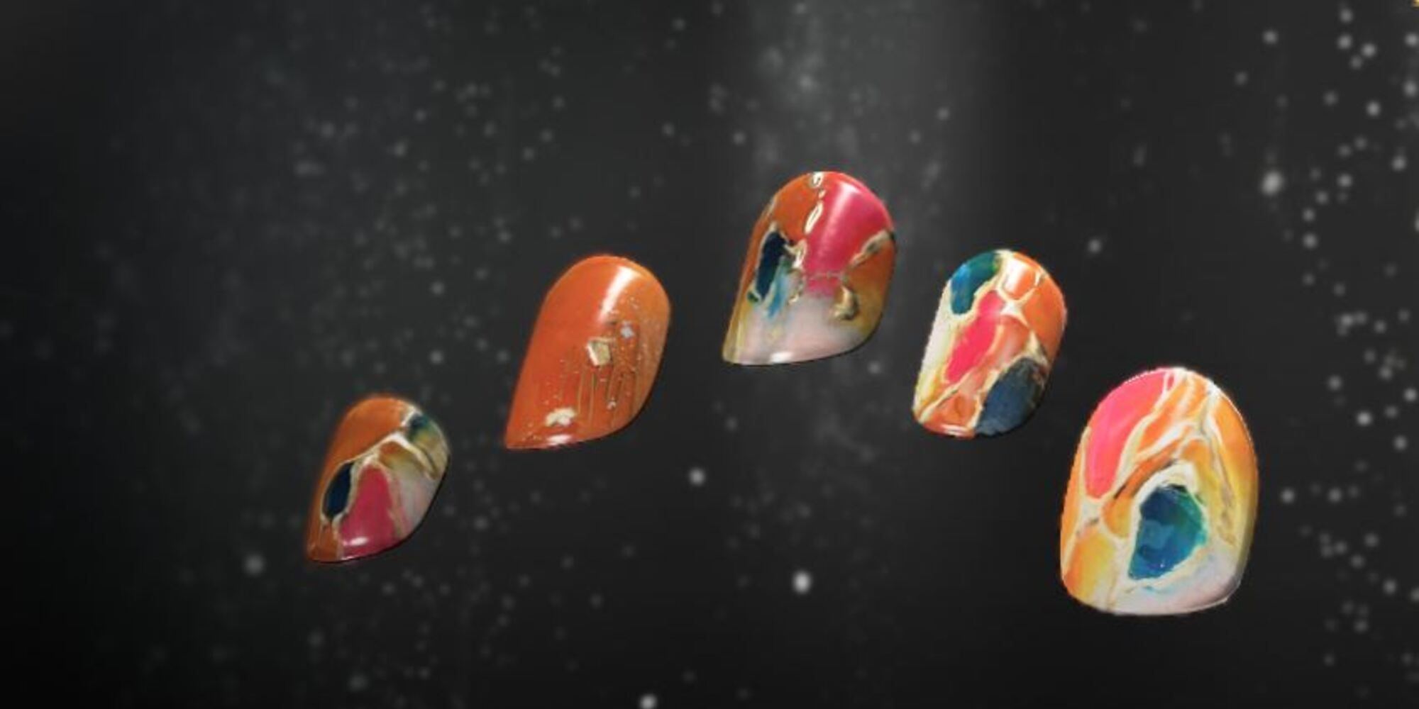 Hope Nails, orange, pink and blue swirls cover the nails in patterned designs.