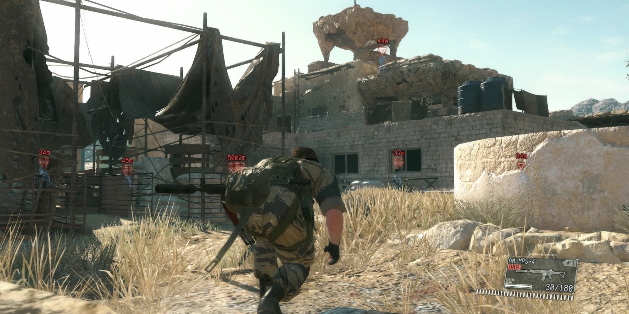Solid Snake sneaks towards an enemy compound.