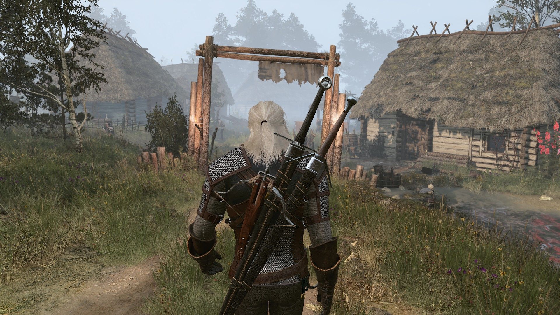 Geralt walks into a sleepy town on a foggy morning in the Witcher 3.