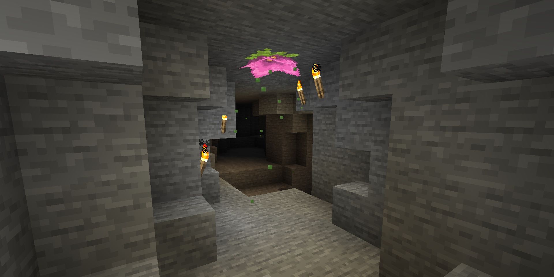 Spores falling from a flower in a cave in Minecraft