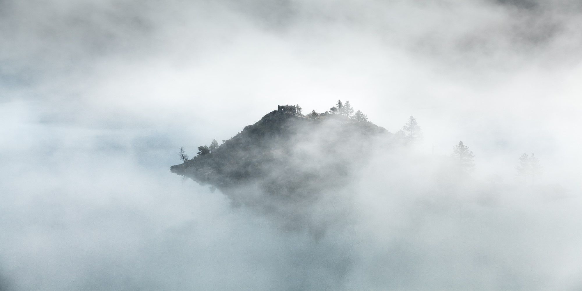 An island floating in clouds and mist.