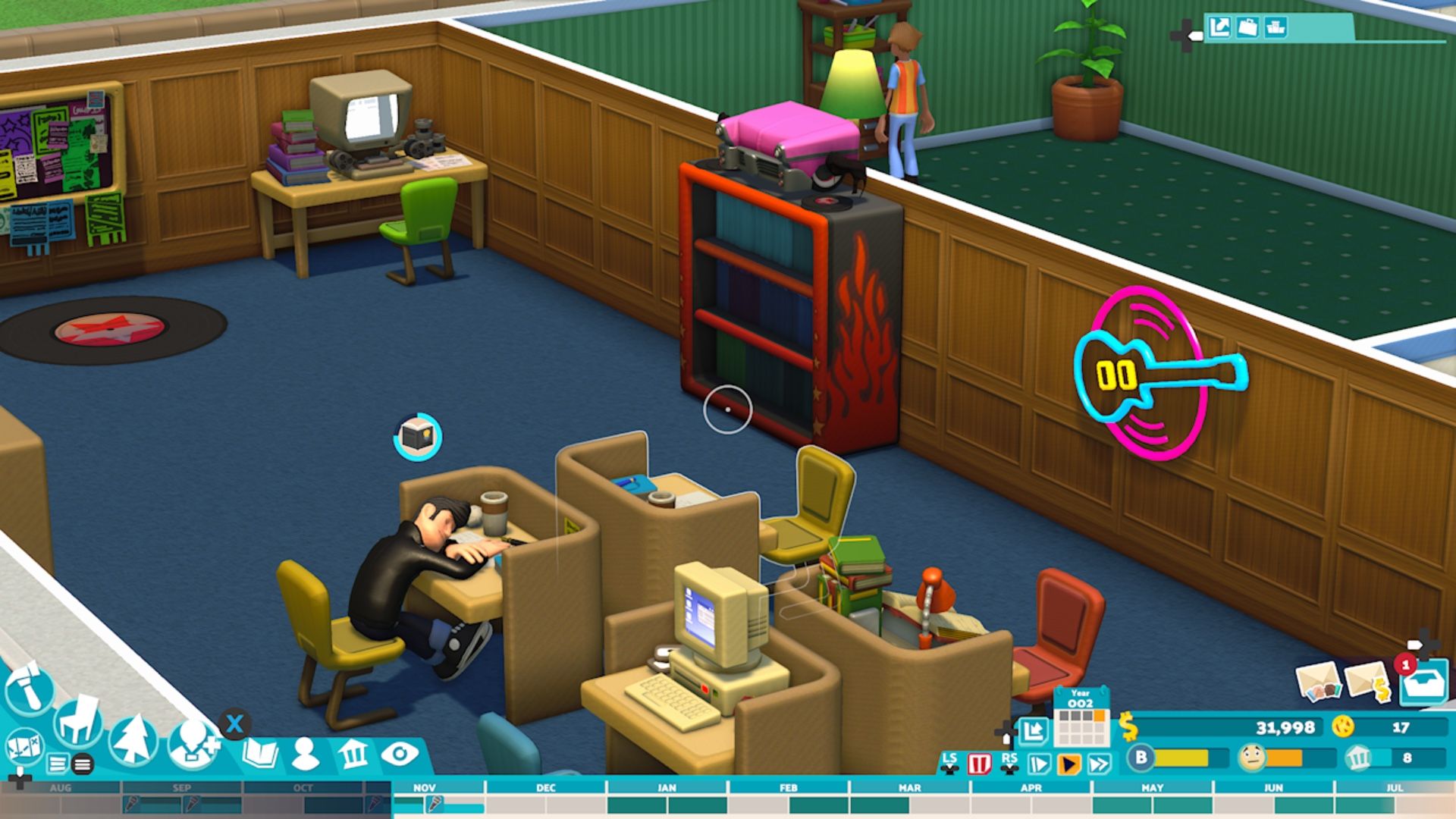 A student sleeps at a desk in front of the Countercultural Studies bookcase in Two Point Campus