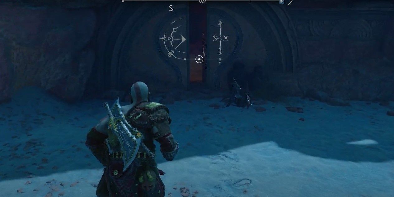 Kratos heading to a door that is ajar in a mountain side