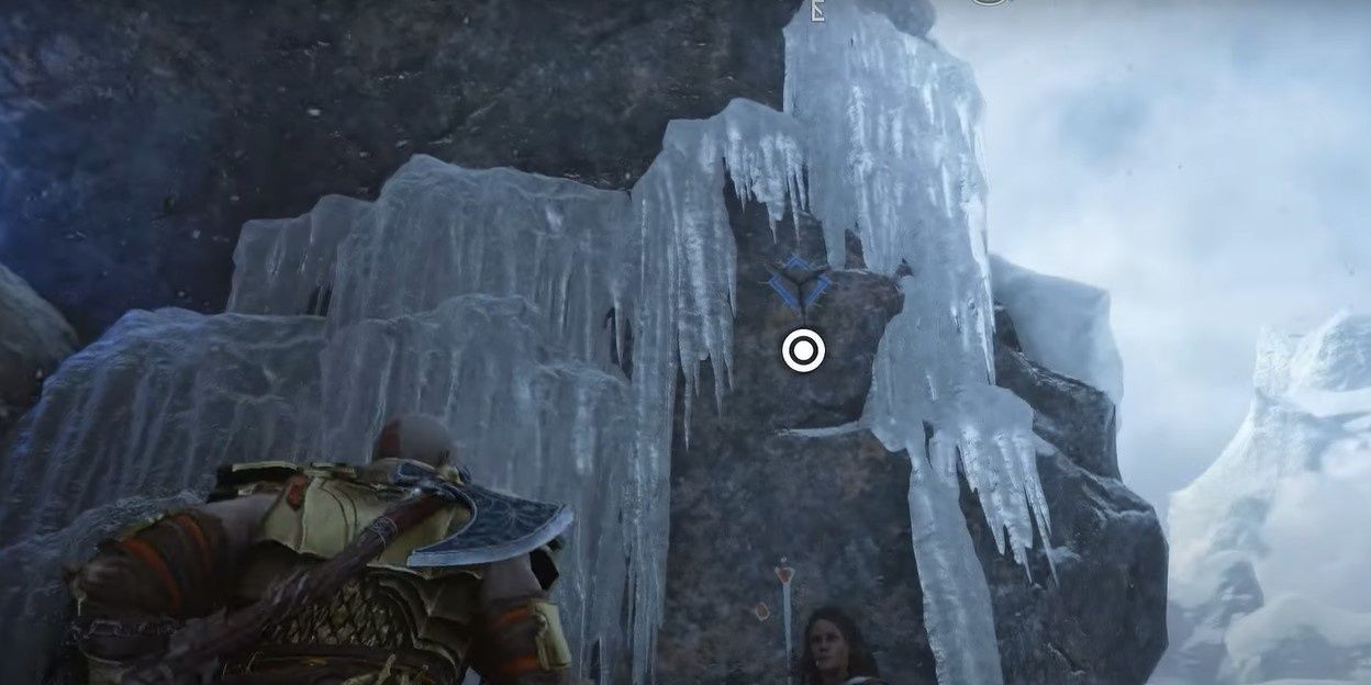 1 Kratos looking at a point to grapple on the rock face in Midgard