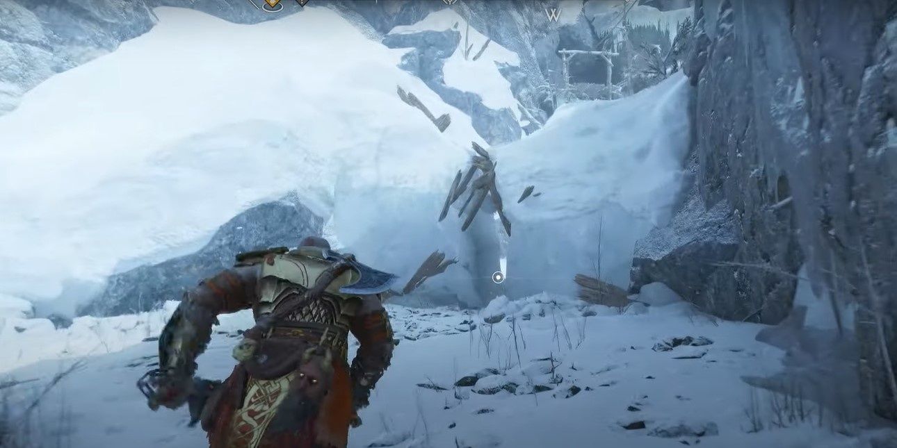 2 Kratos heading to a narrow pass in the snow in Midgard