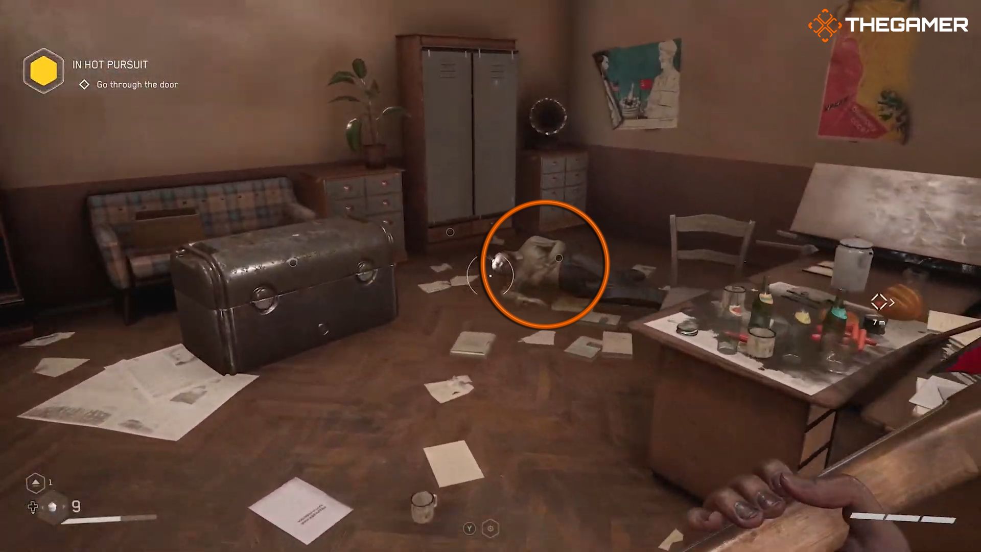 P-3 looking at the body in the center of a cluttered office room