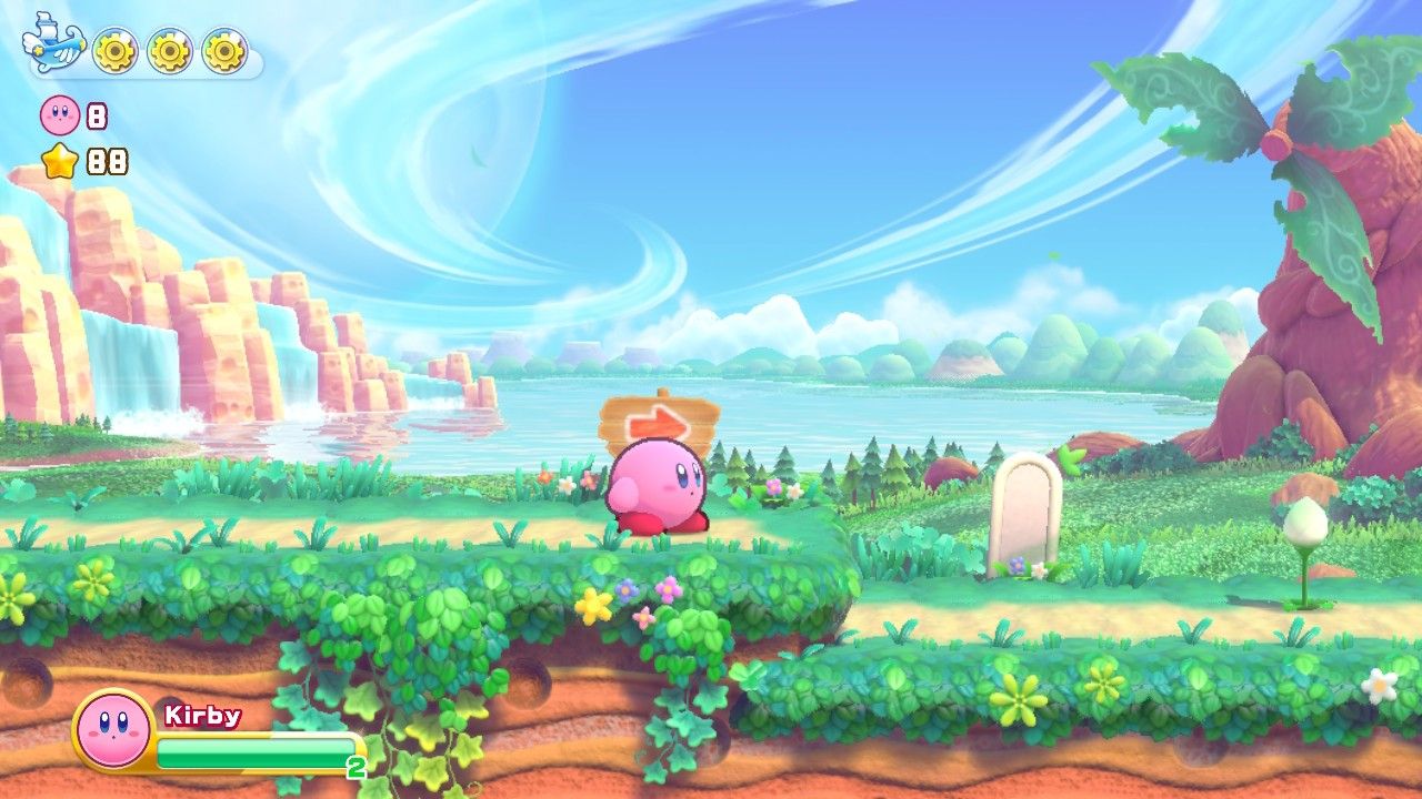 Kirby in front of an arrow pointing right in Stage One of Cookie Country in Kirby's Return to Dreamland Deluxe.