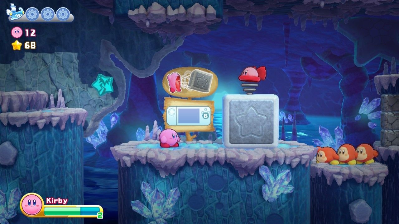 Kirby in front of a huge block with Waddle Dees in a line behind it.