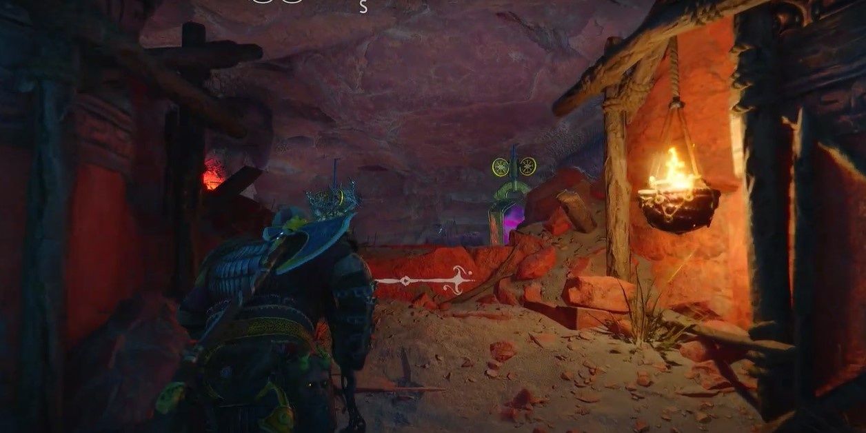 Kratos heading into a cave in the Forbidden Sands