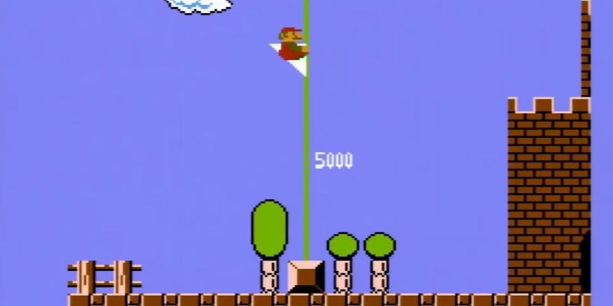 Mario hugging the end goal pole on a stage in Super Mario Bros