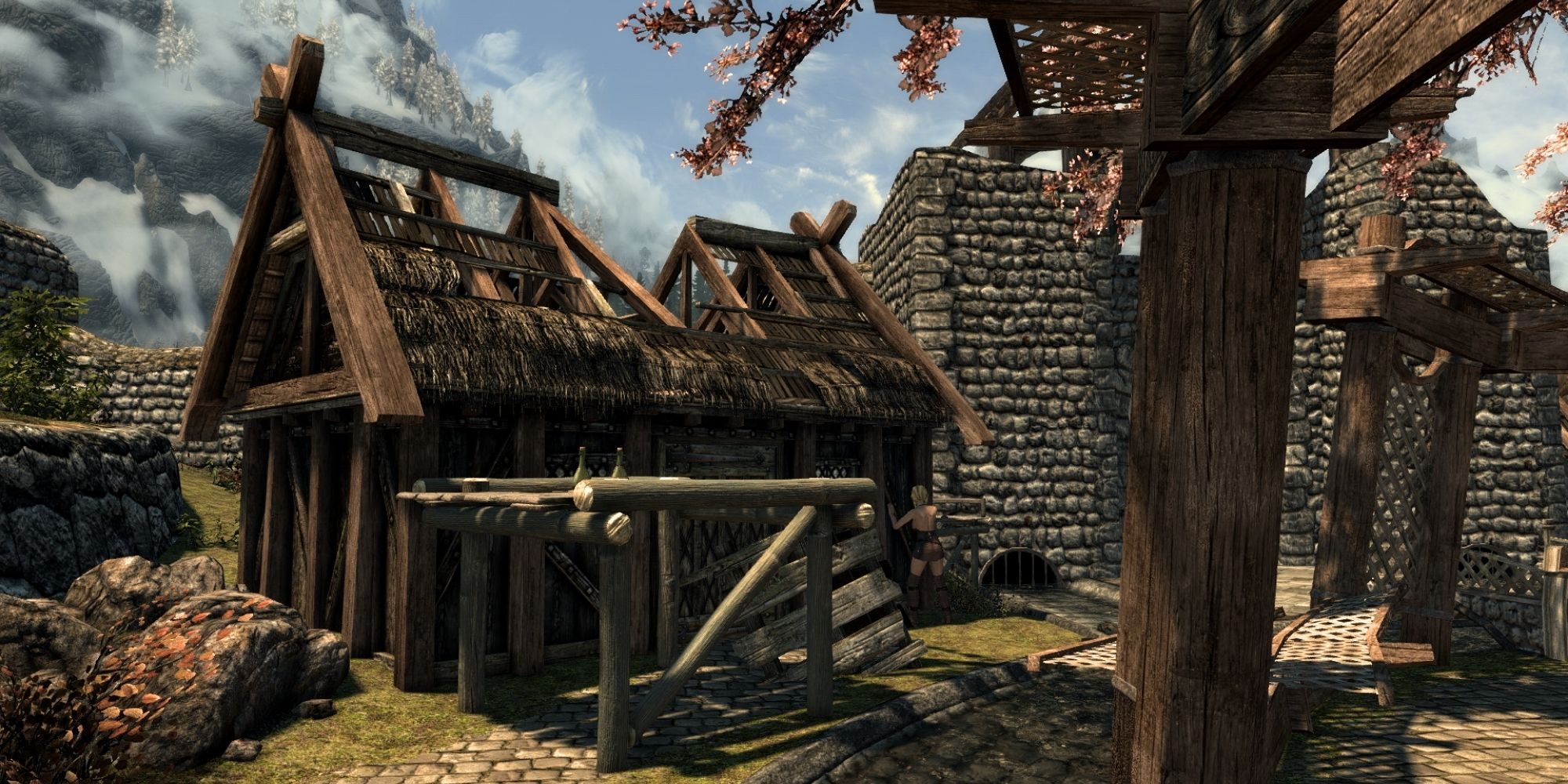 A worker is in the process of repairing a broken but partially reconstructed home in Whiterun