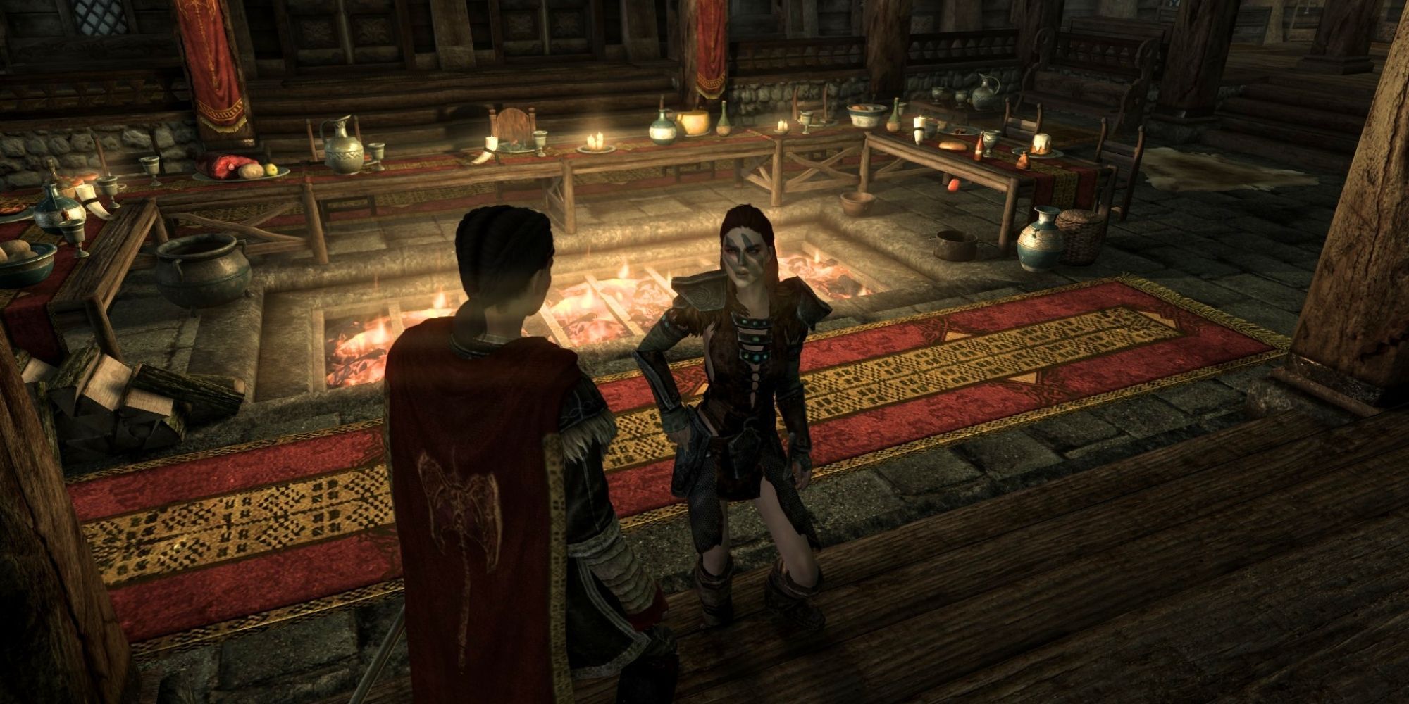 The dragonborn stands in front of Aela as she requests for pelts by Jorrvaskr's dining area