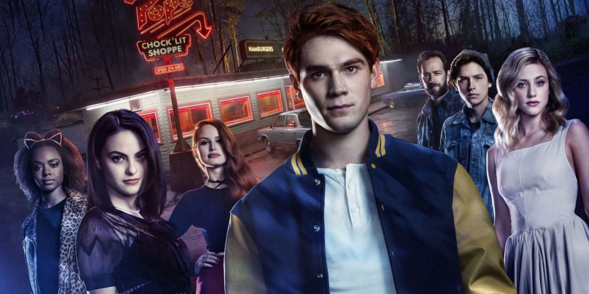 The main cast of Riverdale behind the iconic Pop's Cock 'Lit Shop, featring Archie Andrews at the center.