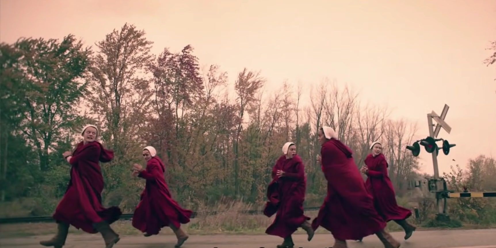 June, Janine, and some of the other Handmaids fleeing from Aunt Lydia and her soldiers across the railroad crossing.