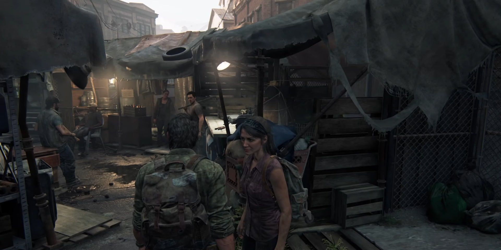 Joel and Tess standing beside each other in a market area in a quarantine zone on their way to Robert. 