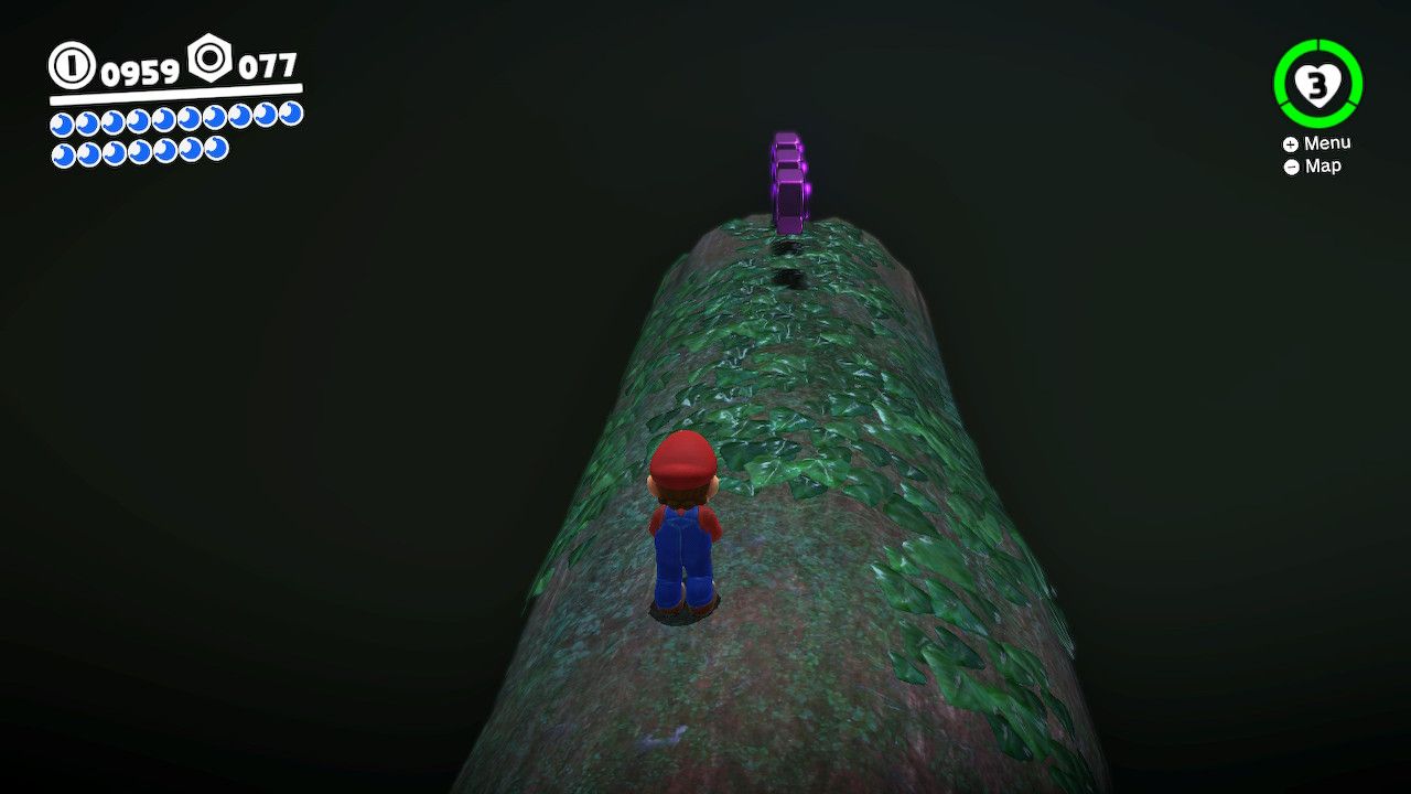 Mario stands on a log and have purple coins in front of him in the Deep Woods in Super Mario Odyssey.