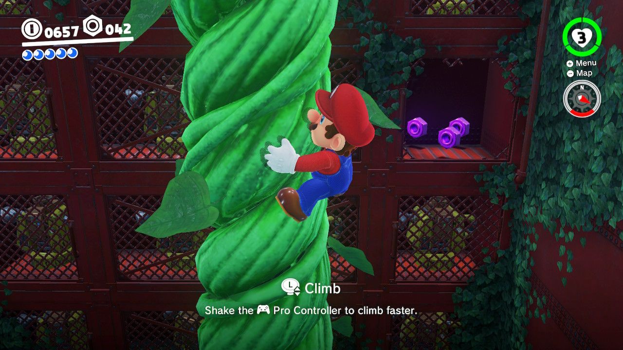Mario climbing a stalk to reach some purple coins in the wall in the Wooded Kingdom in Super Mario Odyssey.
