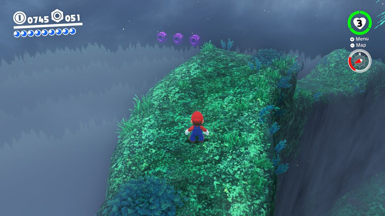 Mario on the edge of the map with some purple coins in the Wooded Kingdom in Super Mario Odyssey.