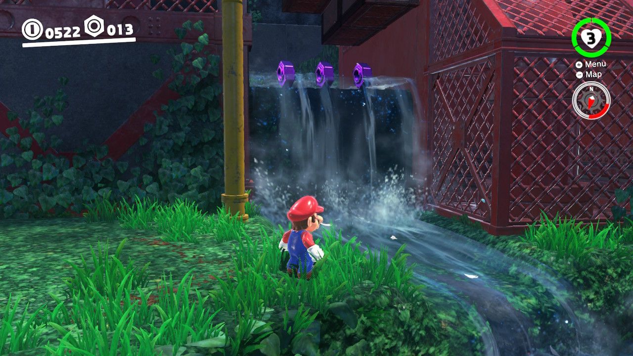 Mario standing next to a waterfall with purple coins on it in the Wooded Kingdom in Super Mario Odyssey.
