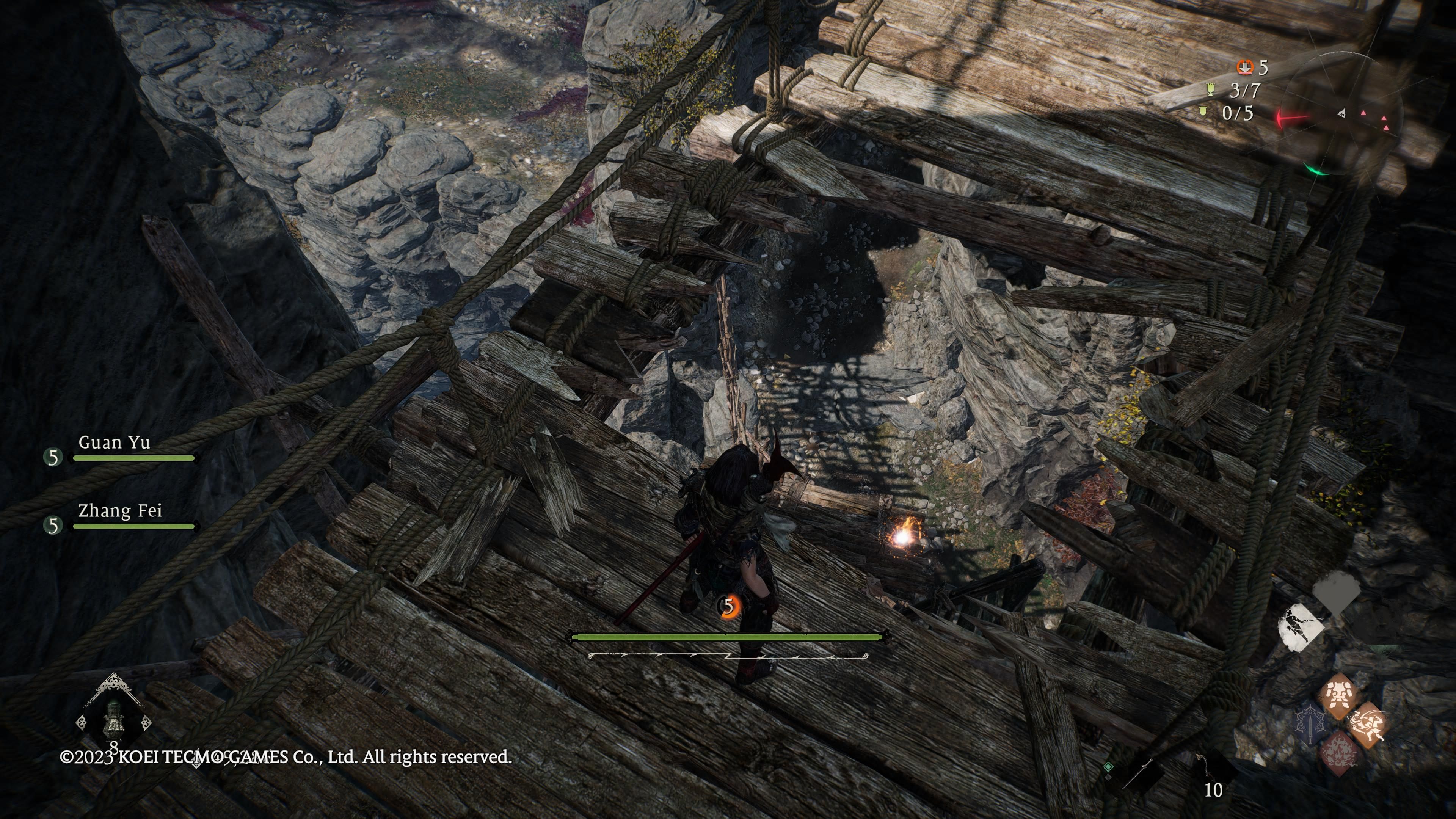 Wo Long: Fallen Dynasty - Looking down through a gap in a bridge, we see an item to grab