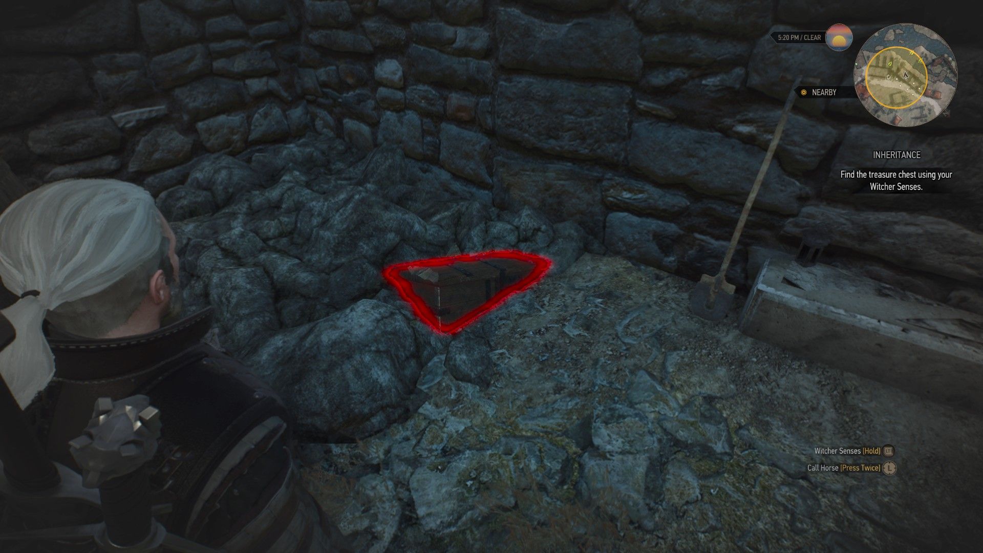 A screenshot of The Witcher 3, with a half-exposed treasure chest sticking out of the ground and outlined in red.