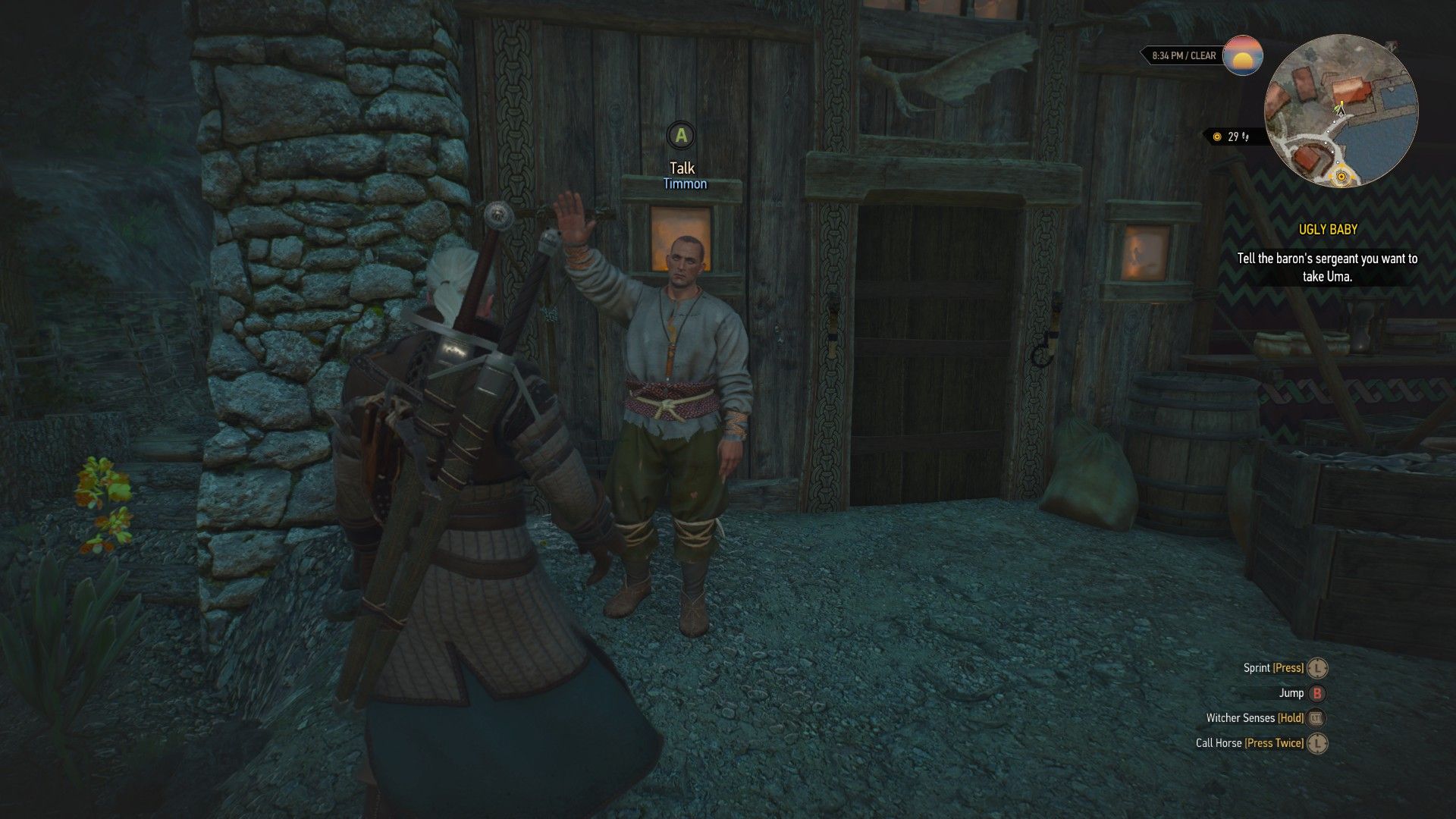 A Skelliger wearing a blue tunic waves at Geralt as he stands outside his wooden house.