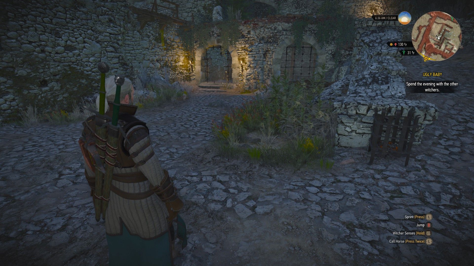 A screenshot of Geralt standing opposite a broken room in Kaer Morhen's courtyard.