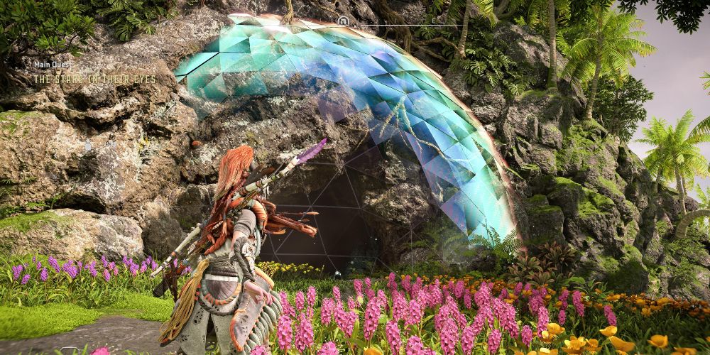 Aloy approaches a cave protected by an energy shield in horizon forbidden west burning shores