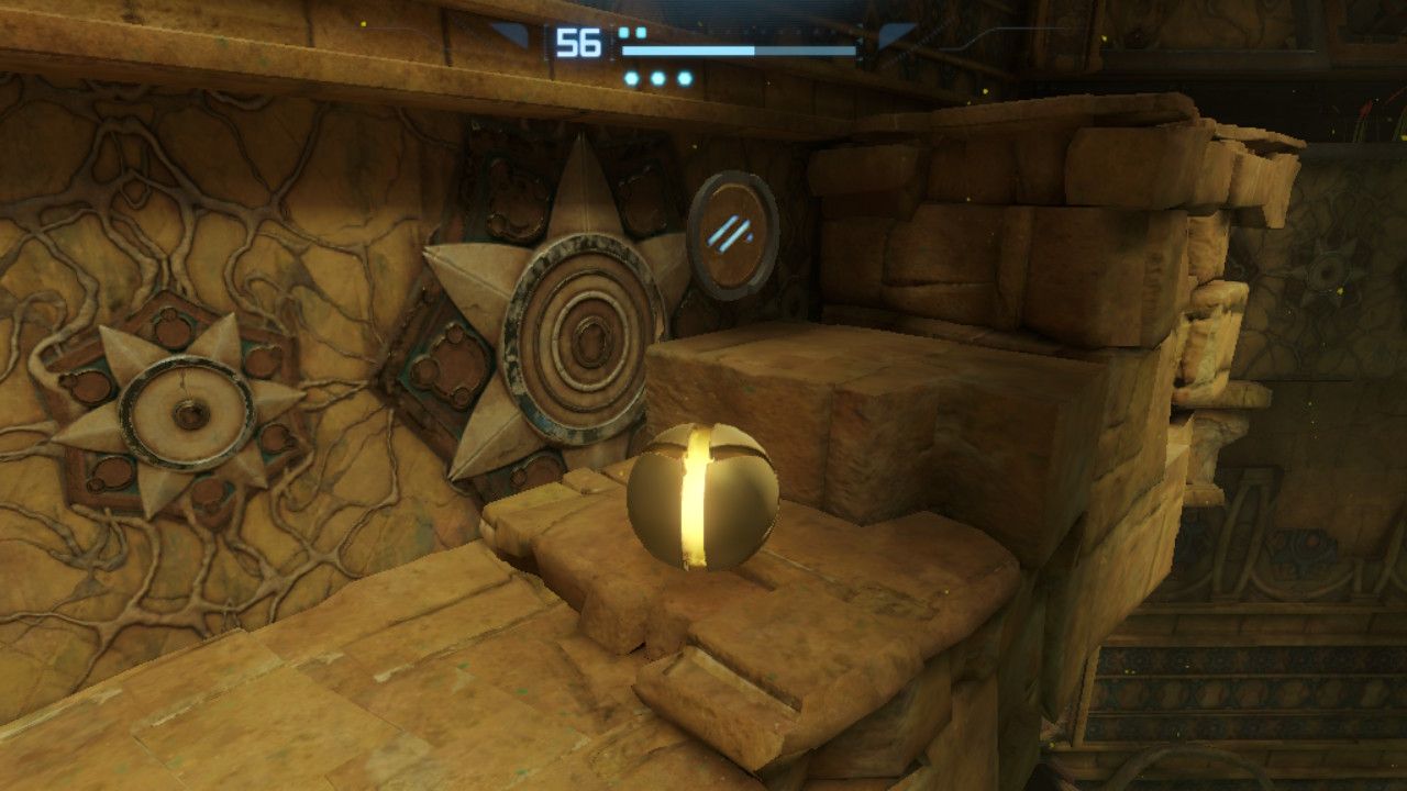 Morph Ball Samus next to one of the four runes in the Arboretum.