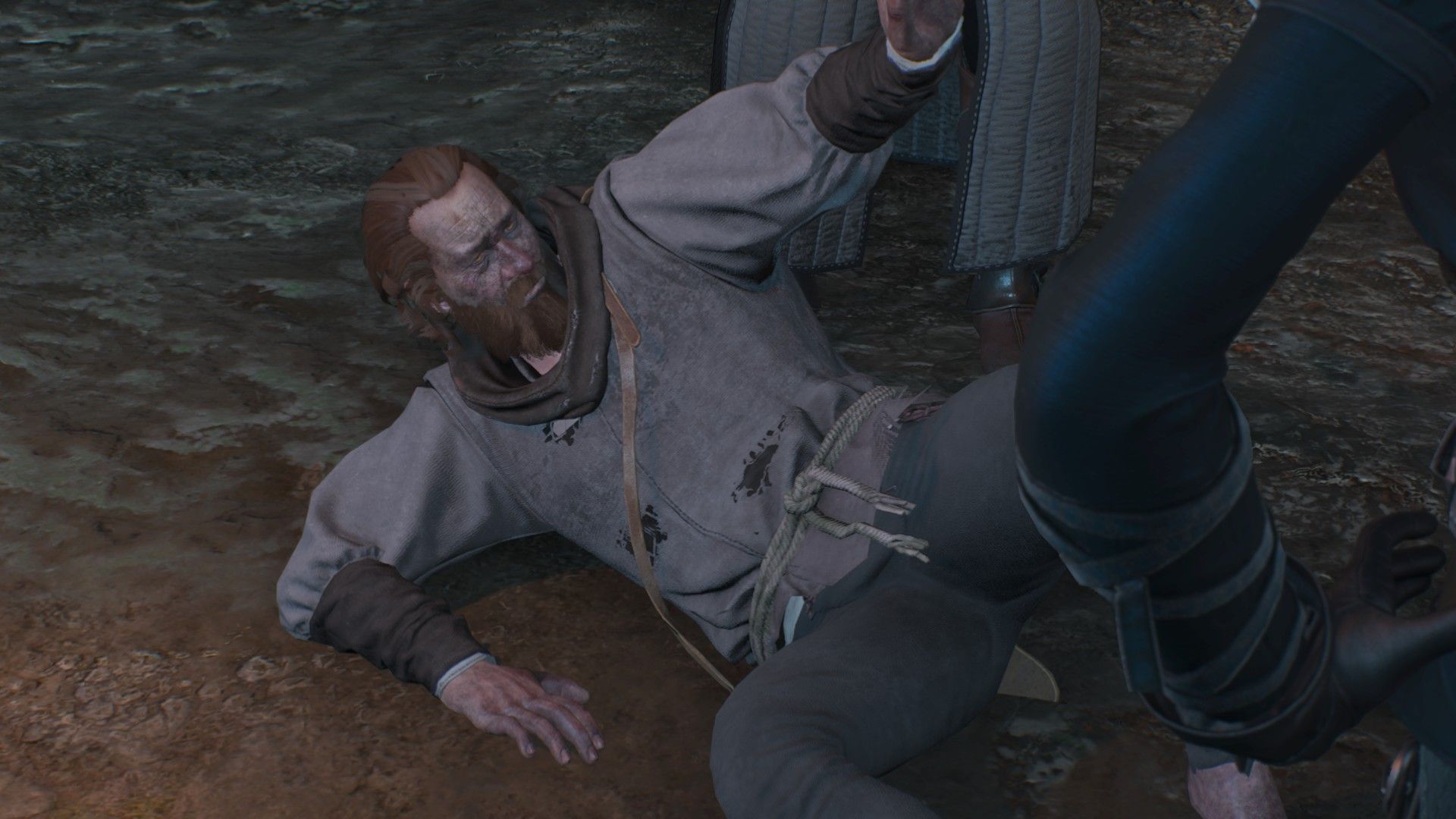 A screenshot of a man holding his arm out for mercy as he is cornered on a street.