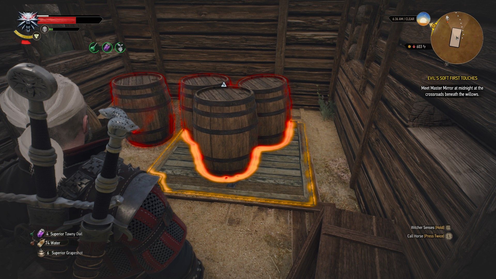 A screenshot of The Witcher 3, with Geralt looking at a set of barrels over a trapdoor, highlighted in red.