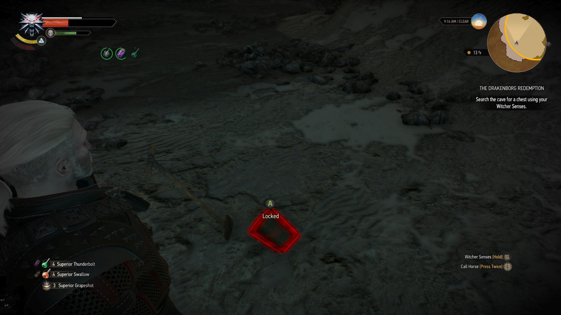 A screenshot of Geralt looking at a half-buried chest in a cave.