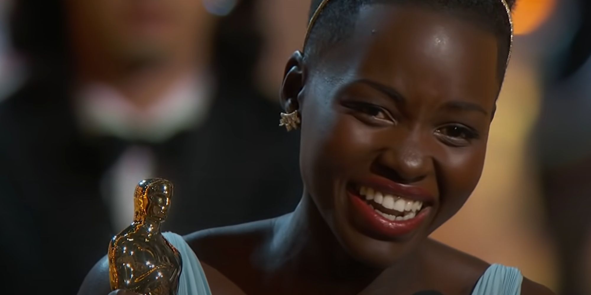 Lupita Nyong'o holding an Oscar