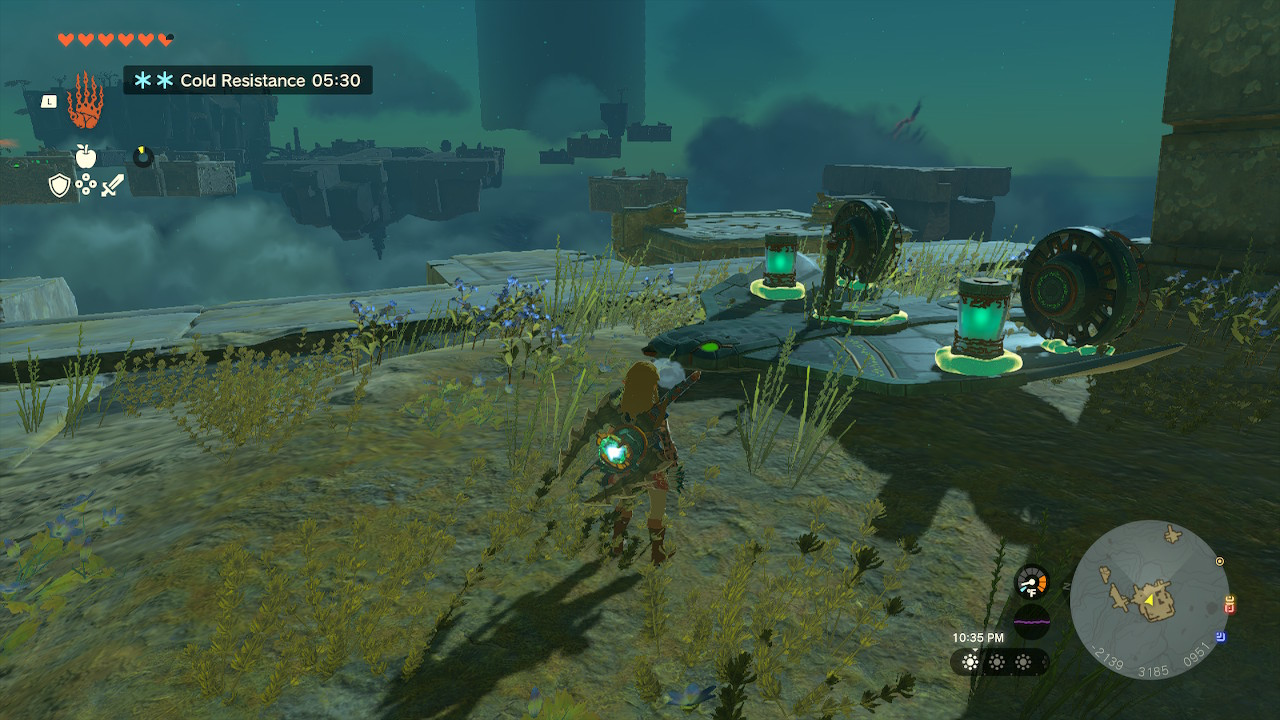 Tears of the Kingdom screenshot of Link standing in front of a Wing Glider with fans, battery packs, and a control system attached