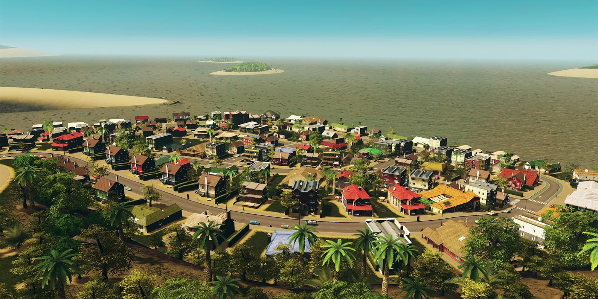A small neighborhood with colorful houses sits near the ocean, surrounded by palm trees in Cities: Skylines - Remastered.