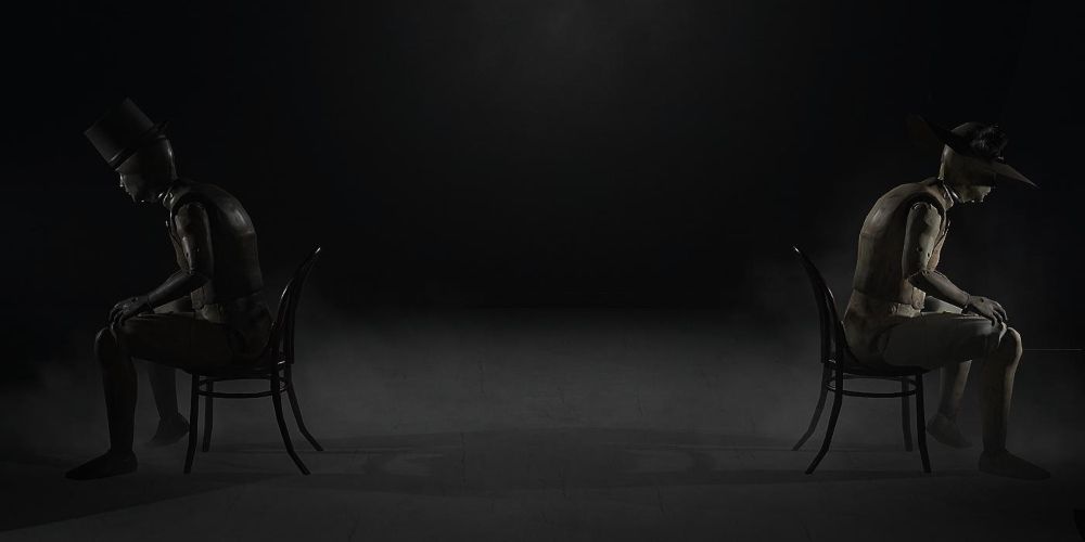 two mannequins seated back-to-back in layers of fear; the left wears a top hat, and the right wears a bonnet