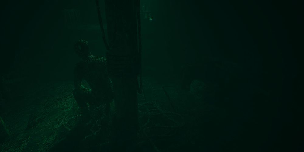 the mast of the sunken pirate ship in layers of fear 2023, with a barnacle-covered mannequin seated to the left