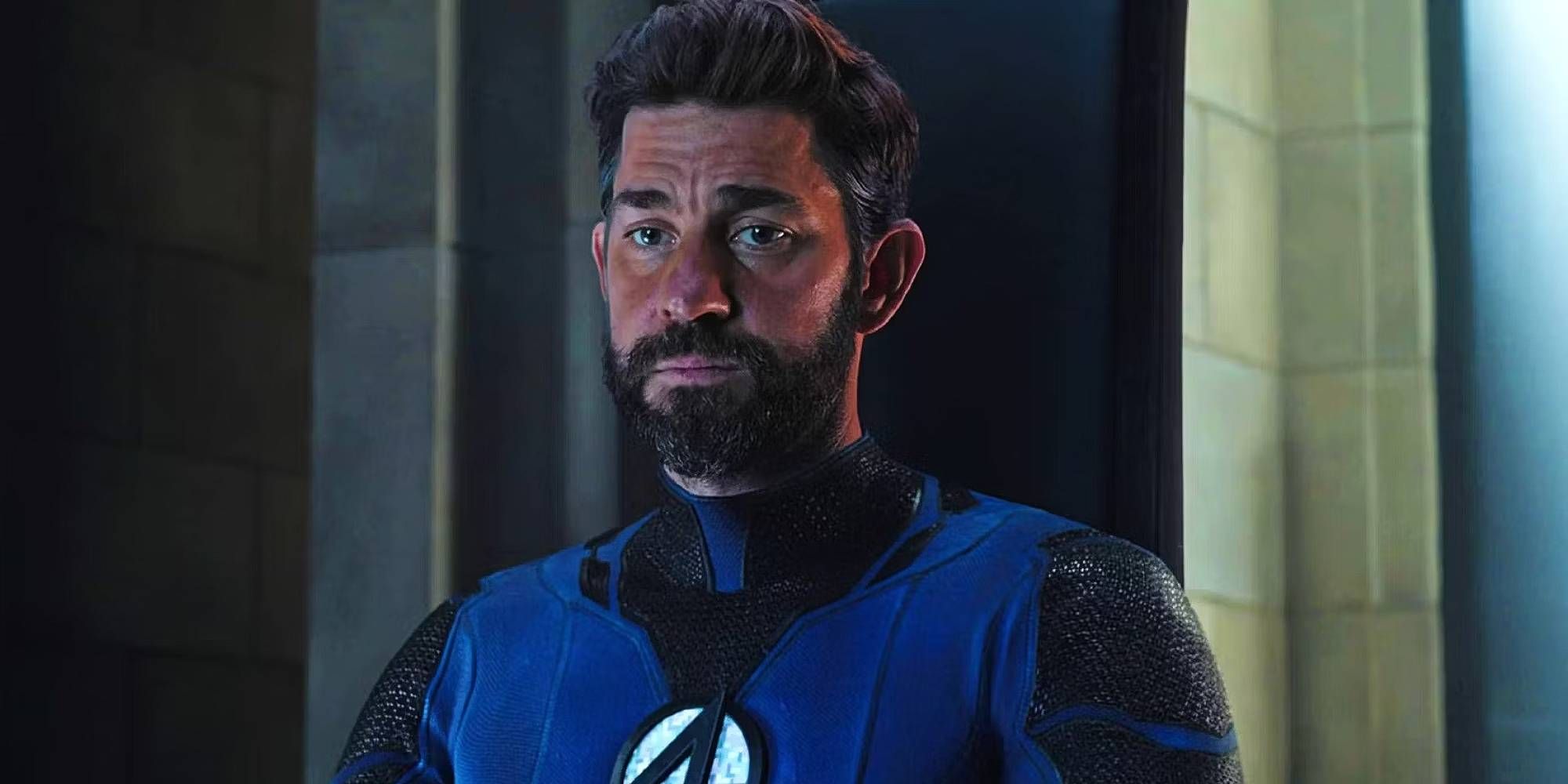 John Krasinski as Mr. Fantastic sitting down in a stony building