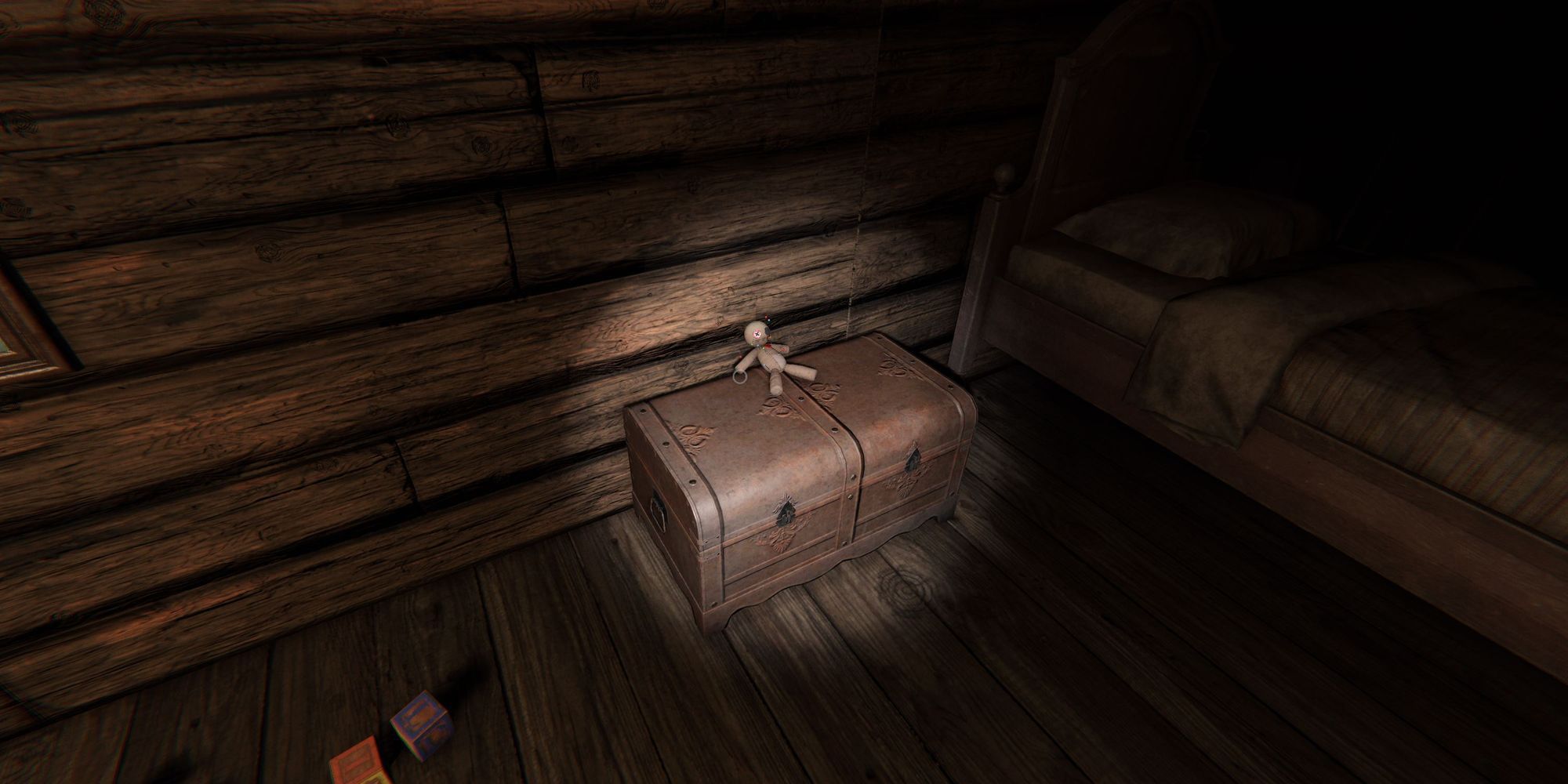 Image depicts a voodoo doll on top of a small leather chest in Grafton Farmhouse in Phasmophobia.