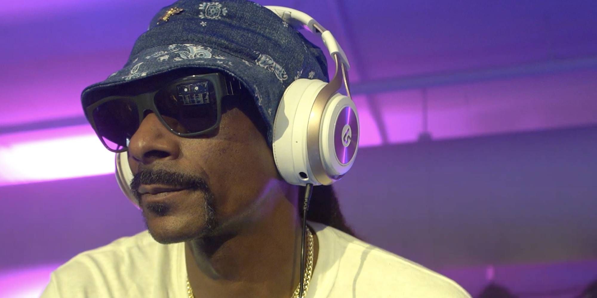 Snoop Dogg sitting down with headphones on his Twitch stream