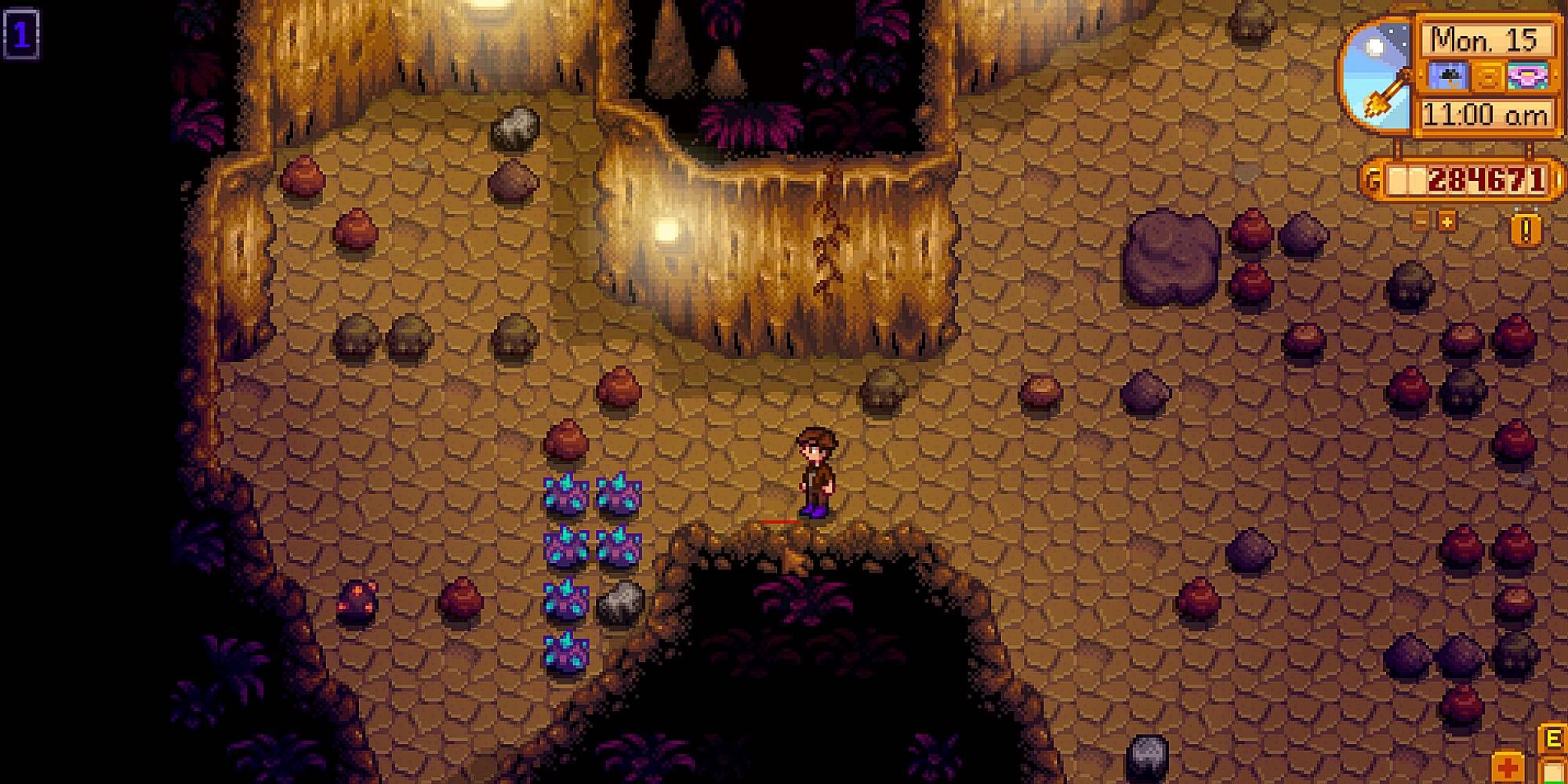 A player is in a well-lluminated cavern speckled with geodes and rocks in Stardew Valley