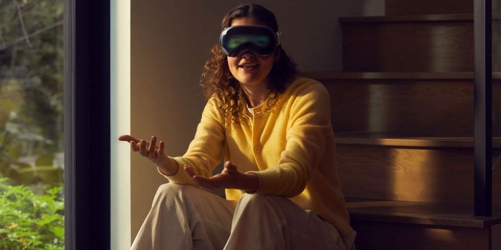 Woman sat on stairs wearing Apple Vision Pro