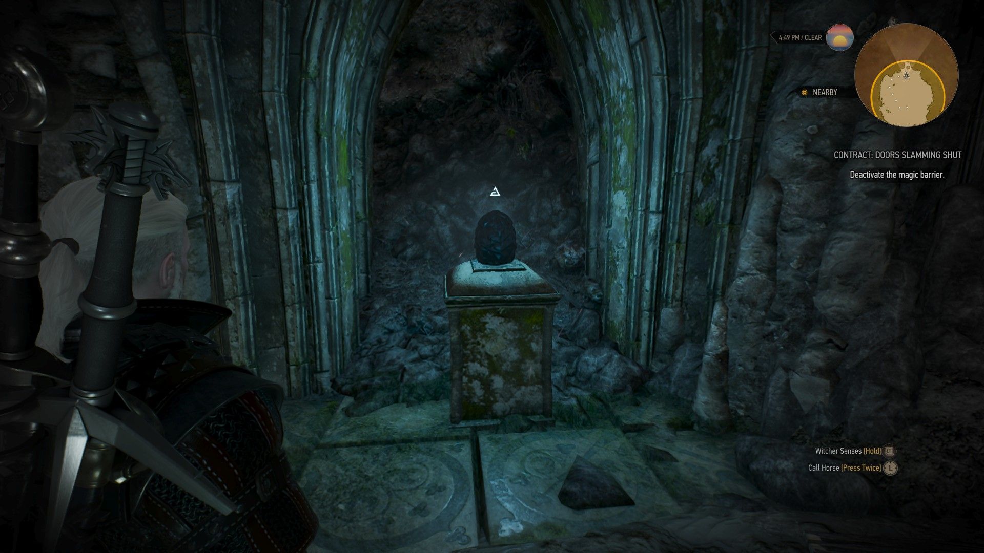 A screenshot of Geralt looking at a magic crystal in an elven ruin.