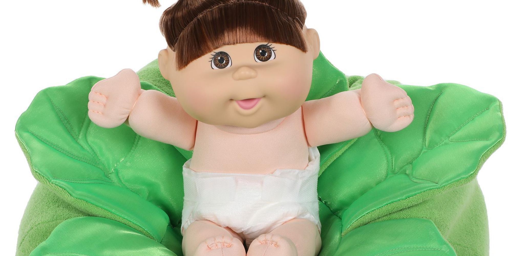up close of cabbage patch kids doll in cabbage leaf container