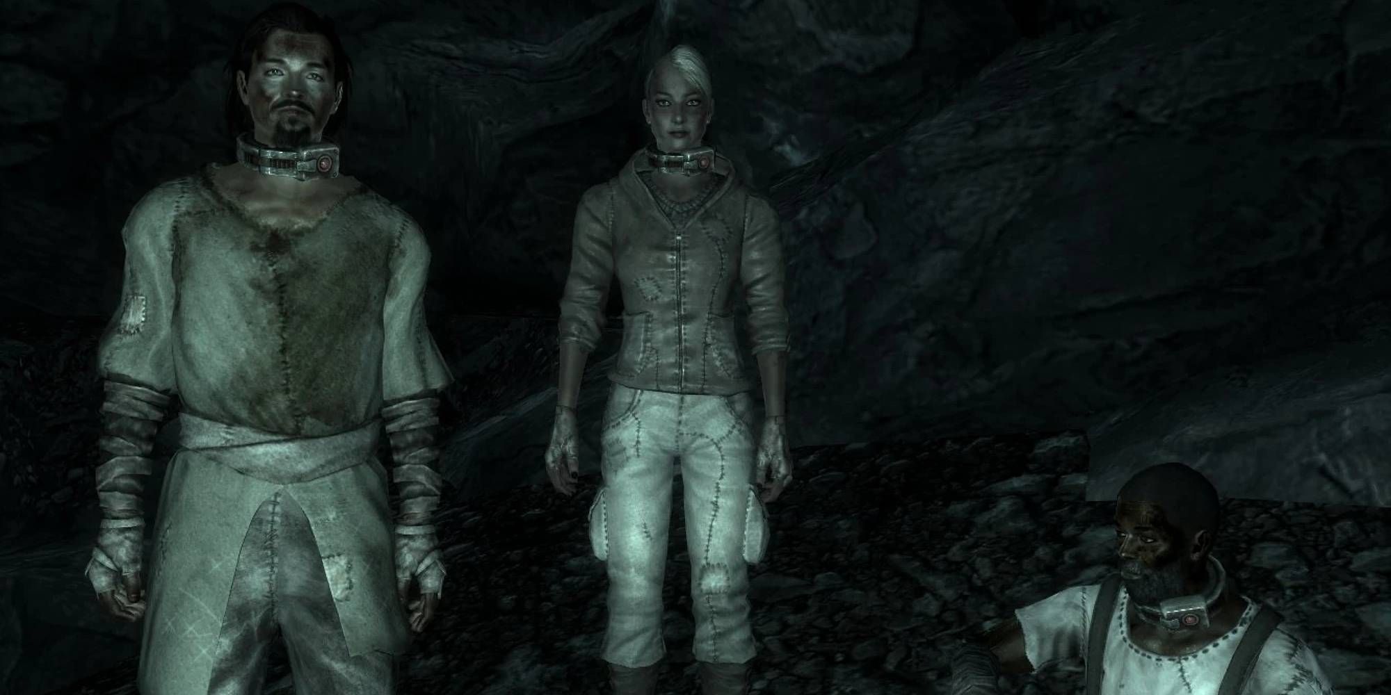 Three figures wearing thick metal collars