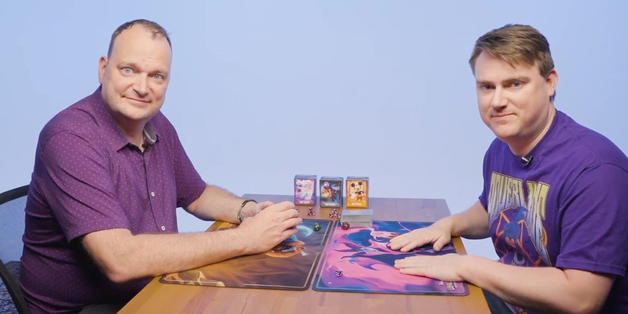 Lorcana gameplay Eric Switzer and Ryan Miller at a table playing